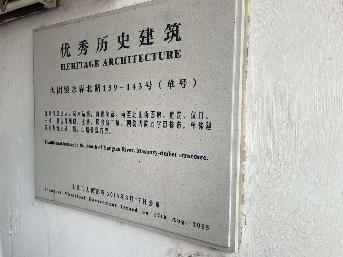 永春北路139-143号の上海市優秀歴史建築の銘板。江南伝統民居と観音兜式山墙の記述